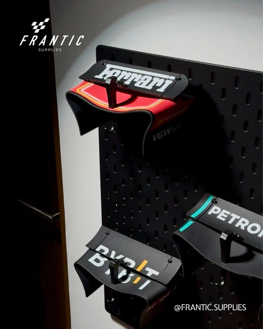 Black pegboard with car part holders featuring Ferrari and Petron branding, branded Frantic Supplies.