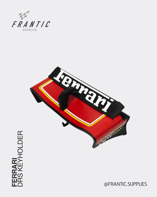 Ferrari DRS keyholder with red body and black strap featuring Ferrari branding on a white background, by Frantic Supplies.